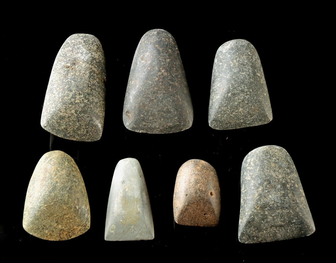 Lot of 7 Miniature Maya Stone Celts: Pre-Columbian, Southern Mexico to Guatemala, Maya, Late Classic Period, ca. 550 to 900 CE. A group of seven Maya polished stone celts of varying size and form, each carefully shaped with tapered bodie