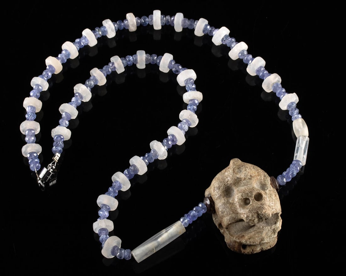 Pre-Columbian Stone Face Pendant & Quartz Bead Necklace: Pre-Columbian, Southern Mexico to Guatemala, Olmec to Maya culture, ca. 500 BCE to 900 CE. A necklace centered with an ancient greenstone face pendant carved in stylized form with drilled suspension p