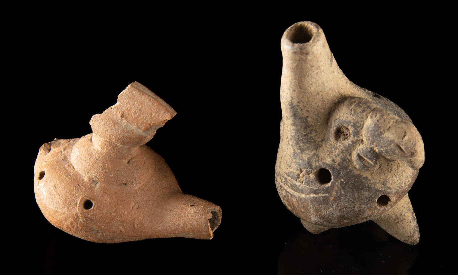 Pair of Costa Rican Pottery Whistles / Ocarinas: Pre-Columbian, Central America, Costa Rica, ca. 500 to 1000 CE. A charming pair of Costa Rican pottery whistles, each formed as a compact figural vessel and still capable of producing sound after cent