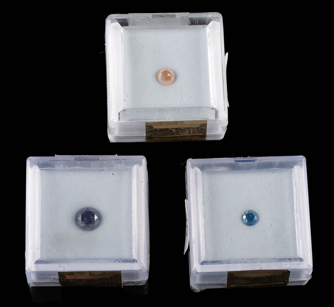 3 Diamond Round Brilliant Solitaires, 0.26 to 1.03 ct!: United States, ca. 21st century CE. Three unmounted diamond solitaires, each offered as a round brilliant cut stone with distinct color character. The group includes a 0.26 carat vivid royal blue
