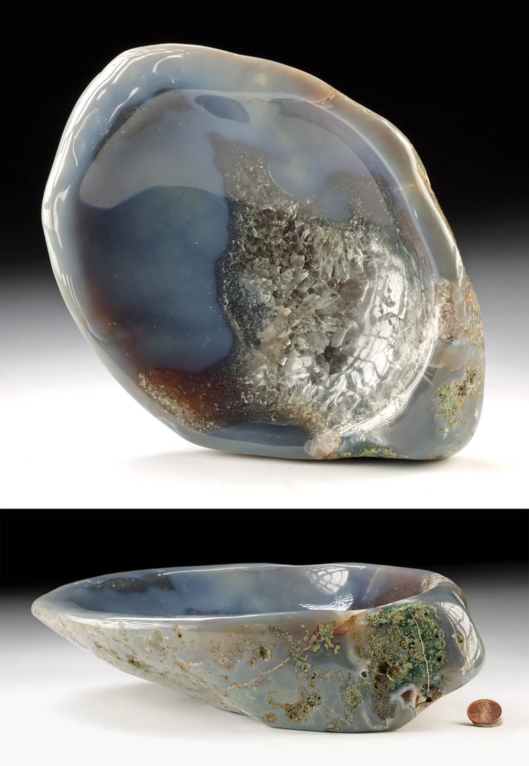 Blue Chalcedony Agate Bowl with Quartz Crystals: Africa, ca. 20th century CE. This polished chalcedony agate bowl features soft blue and creamy tones, with translucent areas that reveal natural quartz crystalline formations within the stone. Carved