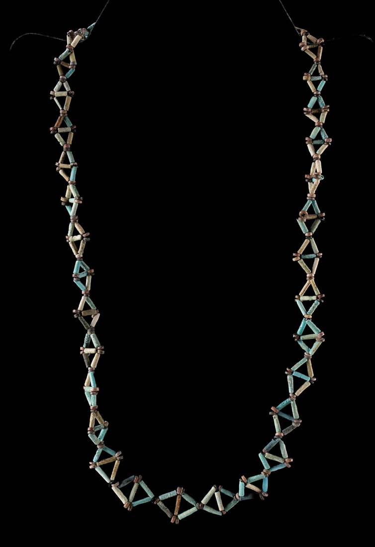Wearable Ancient Egyptian Faience Bead Necklace: Egypt, New Kingdom to Late Period, ca. 1550 to 332 BCE. A necklace composed of ancient faience tubular beads in shades of turquoise, pale blue, and cream, interspersed with small reddish-brown spacer