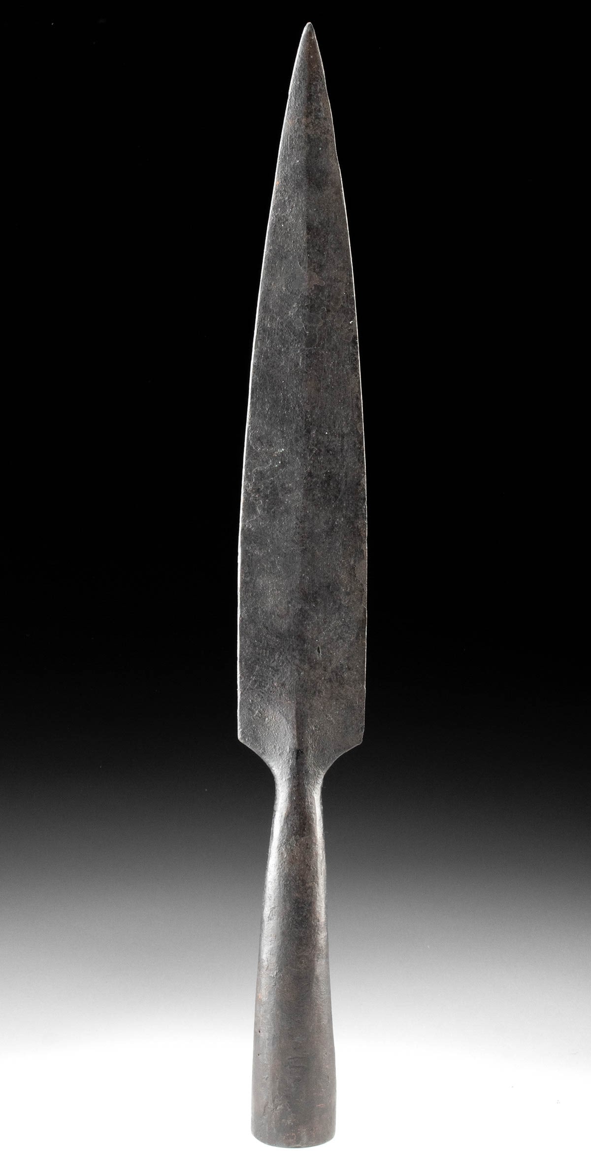Large Post-Medieval Iron Socketed Spearhead: Western Europe, Post-Medieval period, ca. 15th to 18th century CE. A robust iron socketed spearhead displaying a long, leaf-shaped blade and tapered socket, characteristic of weaponry used across