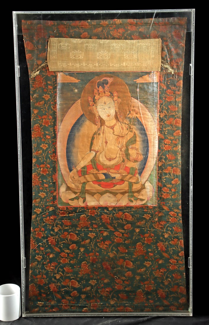 Tibetan 19th C. White Tara All Seeing Thangka Painting: Central Asia, Tibet, ca. 19th to early 20th century CE. A canvas thangka painting of White Tara in a serene frontal pose, seated in full lotus position on a lotus throne and encircled by halo, with je