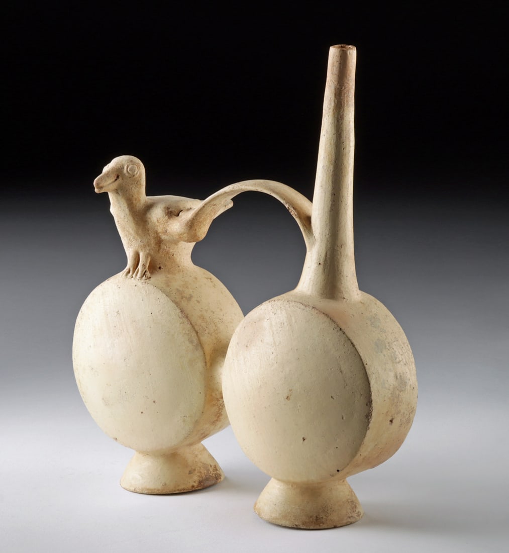 Chancay Double Chambered Whistle Vessel w/ Bird Effigy: Pre-Columbian, Central Coast Peru, Chancay, ca. 1000 to 1500 CE. A double-chambered pottery whistling vessel featuring two rounded bodies joined by a strap handle that rises into a tall, tapering spou