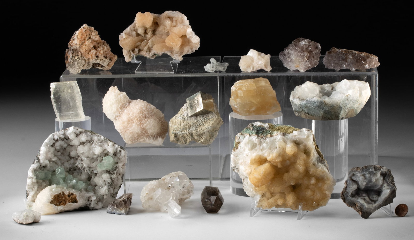 Crystals: Quartz Points, Geode, Pyrite & Stilbite: India & North America, ca. million of years ago. A mixed group of mineral specimens including quartz points, a cut geode, smoky quartz, pyrite, stilbite, pale amethyst, and green apophyllite with stil