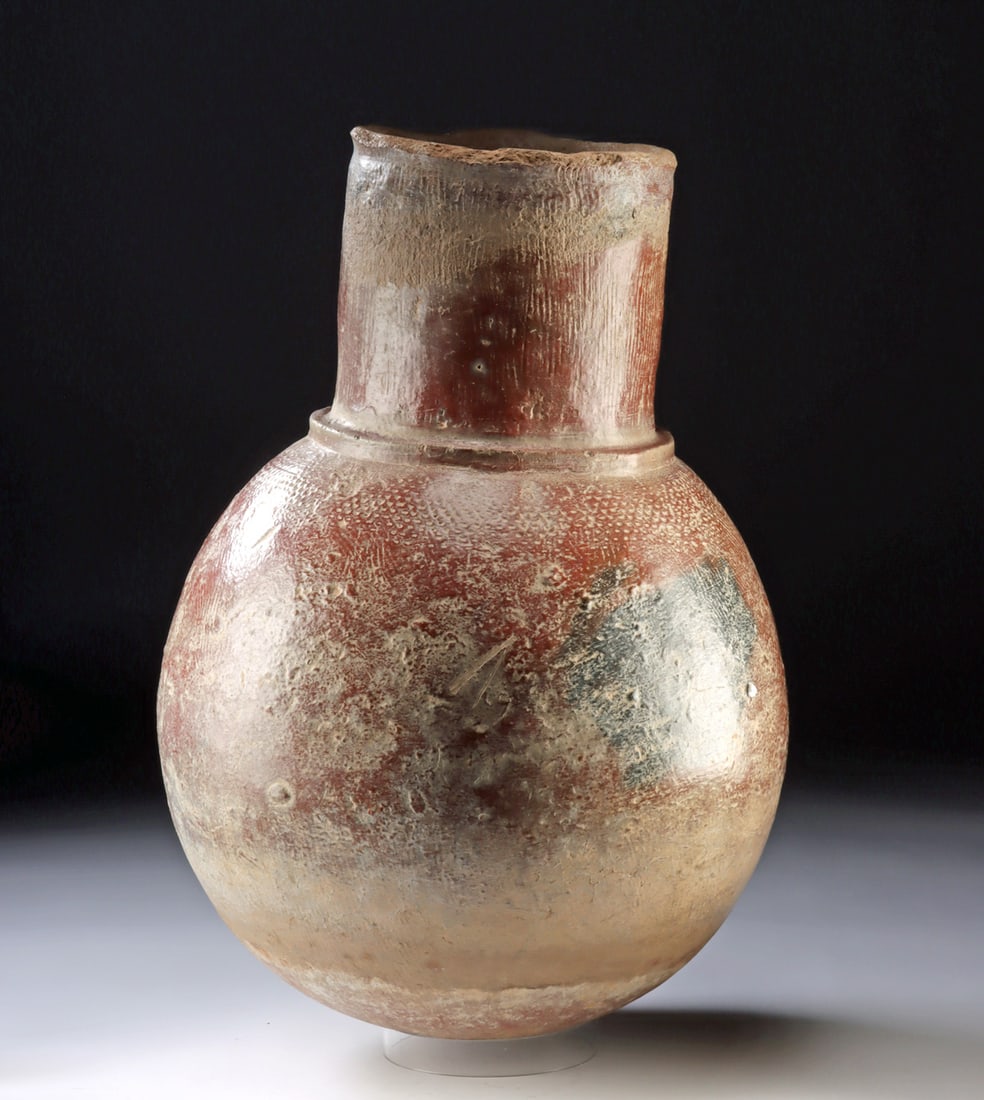 Large Mali Djenne Region Earthenware Storage Vessel: West Africa, Mali, Djenne region, ca. 16th to 19th century CE. A large and weighty pottery vessel with a globular body and tall cylindrical neck, its surface marked by incised and impressed decoration