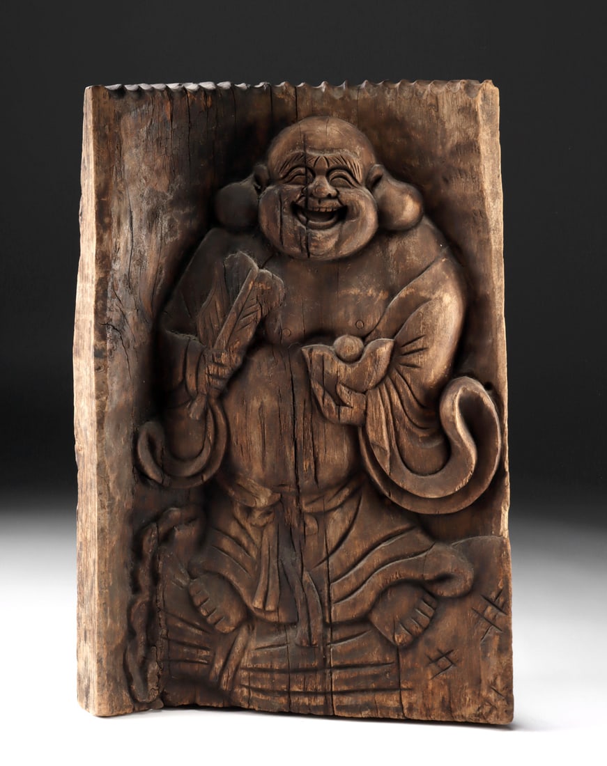 19th C. Wood Relief Panel Laughing Budai of Wealth: East Asia, China or Japan, Qing / Meiji era, ca. 19th to early 20th century CE. A large curved wooden panel carved in relief with a laughing, rotund Budai (Hotei) figure, shown holding a fan and a cre
