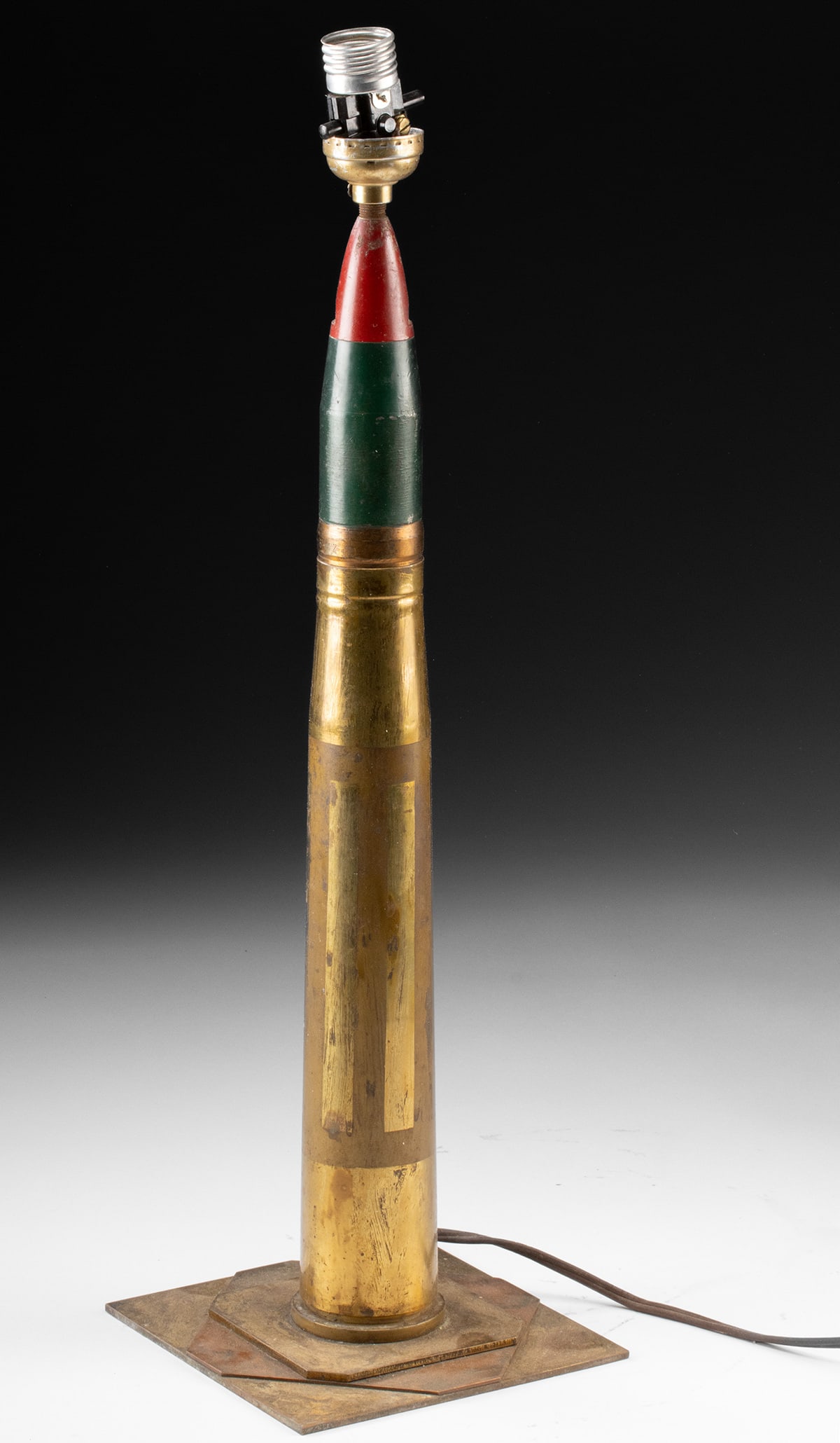 WWII Trench Art Artillery Shell Table Lamp: Europe or United States, World War II, ca. 1939 to 1945 CE. A formidable relic of wartime industry transformed into functional design, this World War II artillery shell has been ingeniously converted