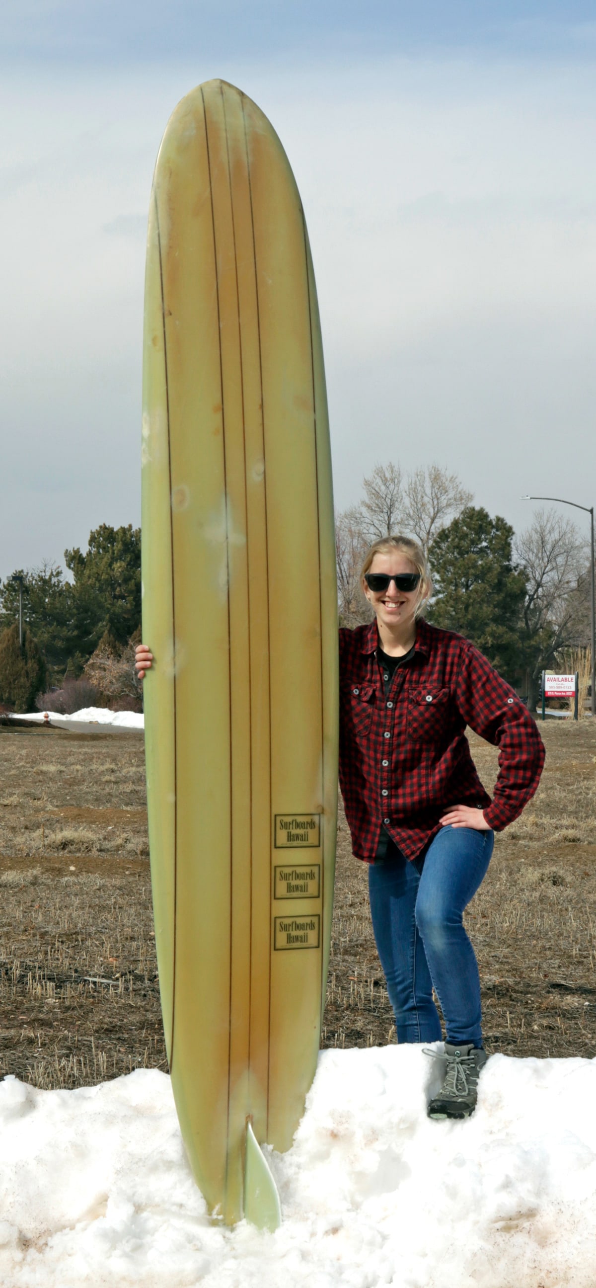 1960s Hawaiian Fiberglass Surfboard: United States, Hawaii, ca. 1960s CE. A beautiful cream-colored vintage fiberglass surfboard bearing the repeated logo "Surfboards Hawaii Haleiwa Hawaii Encinitas California". Surfboards Hawaii was fou