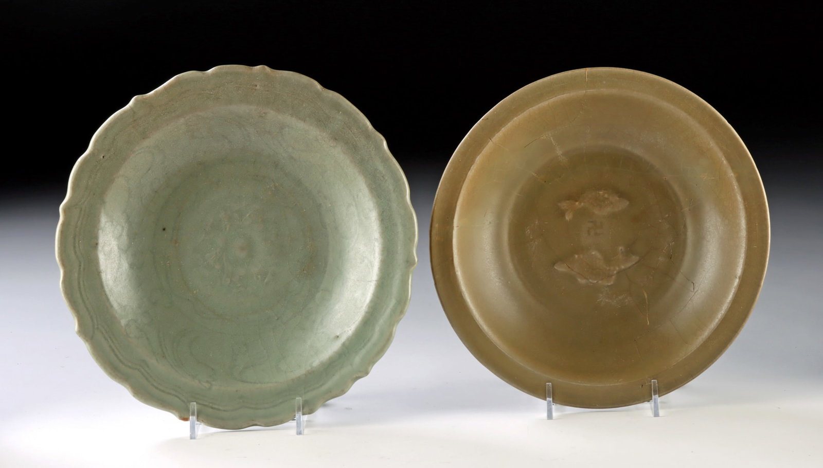 2 Yuan & Ming Celadon Bowls - Twin Fish & Lotus Motifs: East Asia, China, Longquan kilns, Yuan Dynasty, ca. 13th to 14th century CE; Ming Dynasty, ca. 14th to 17th century CE. A scholarly pair of celadon-glazed bowls: the larger a Ming dish with an elegant