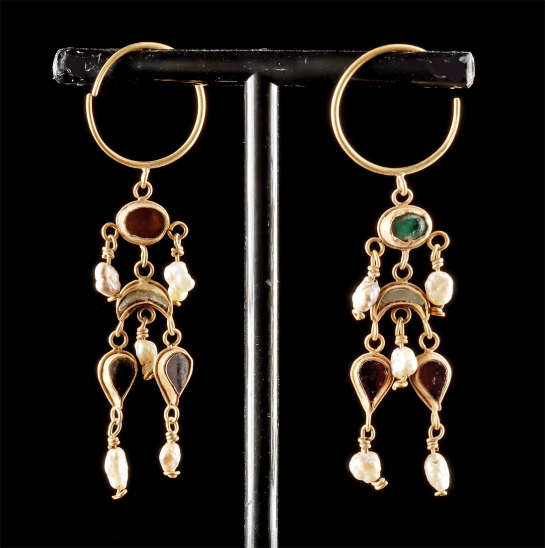 Roman Gold Earrings w/ Emerald, Amethyst, & Pearls: Roman, Imperial period, ca. 1st to 3rd century CE. A graceful pair of Roman gold chandelier earrings that balance color, movement, and light, designed to shimmer with every turn of the head. Suspended