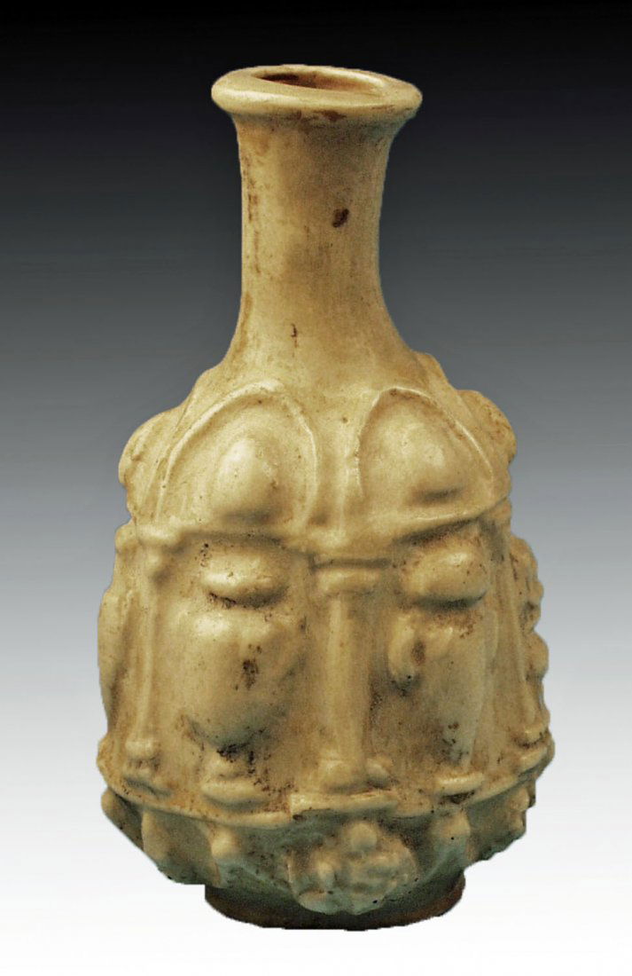 Roman Milky White Glass Hexagonal Bottle: Sidon, ca. 25 - 50 CE. Ancient hexagonal glass bottle with six panels separated by columns, each with an image of a different vase (amphora, krater, hyrdia, etc), grape clusters below. Milky white mol