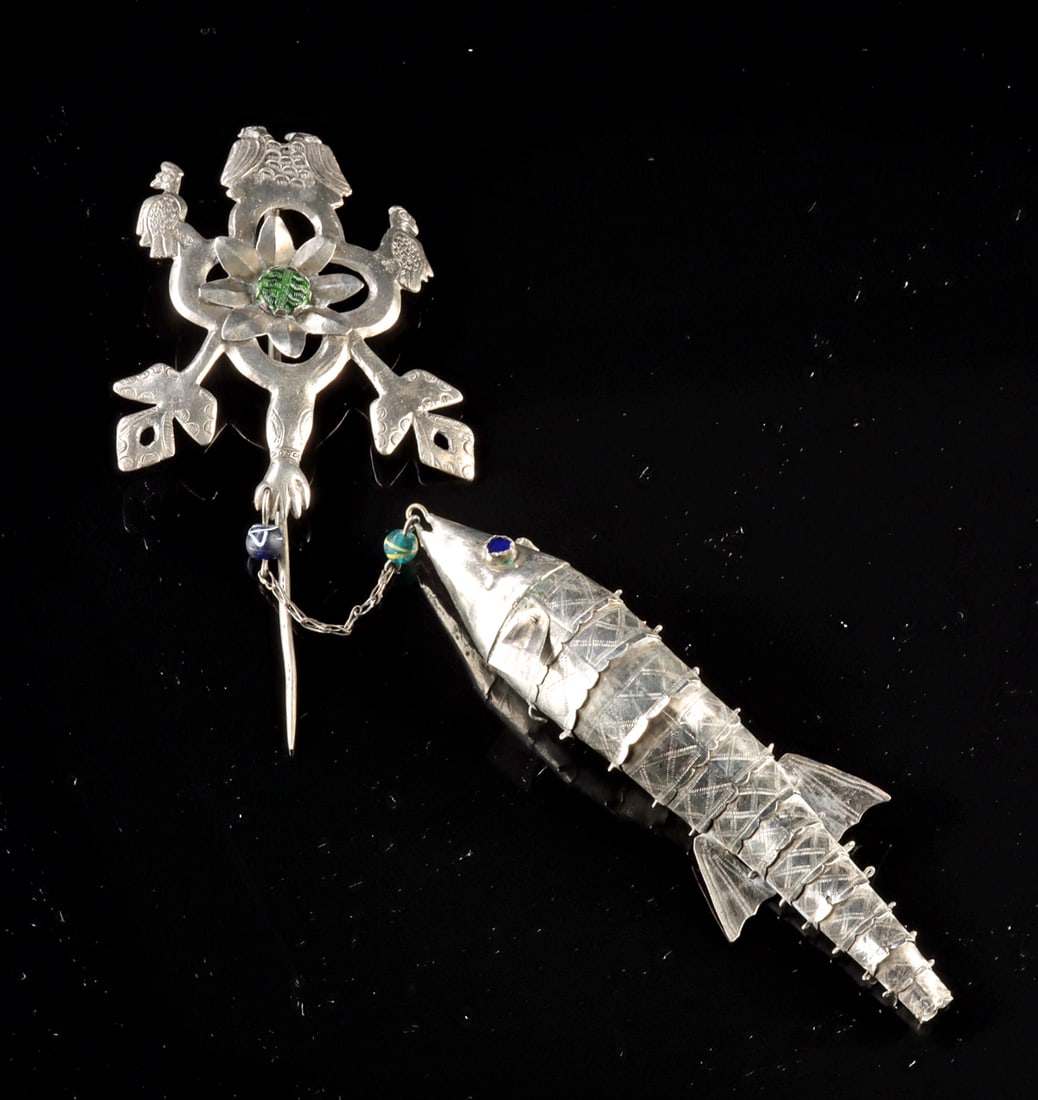 Andean Silver Tupu Pin - Fish & Peacock Pendant: South America, Andean region, ca. 20th century CE. A lively 20th century Andean silver tupu pin featuring a finely worked articulated fish pendant and a stylized peacock-form head, accented with inlai