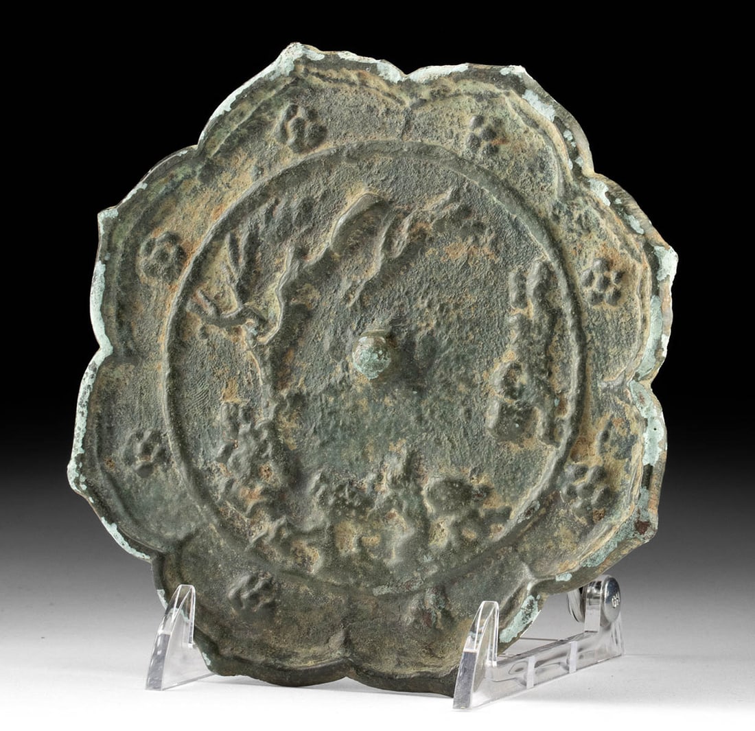 Chinese Tang Dynasty Chinese Bronze Mirror w/ Tree: East Asia, China, Tang Dynasty, ca. 618 to 907 CE. A cast leaded bronze mirror of lobed, petal-like form, each of its eight scalloped edges adorned with a petite floral motif. At the center, a raised