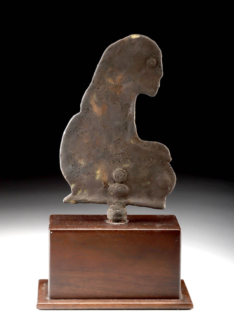 Early Balinese Ritual Kneeling Figure / Shrine Element: Southeast Asia, Indonesia, Bali, ca. 19th to early 20th century CE. A cast metal figure depicting a kneeling human form in profile, with hands resting on the knee and a deliberately flattened silhouet