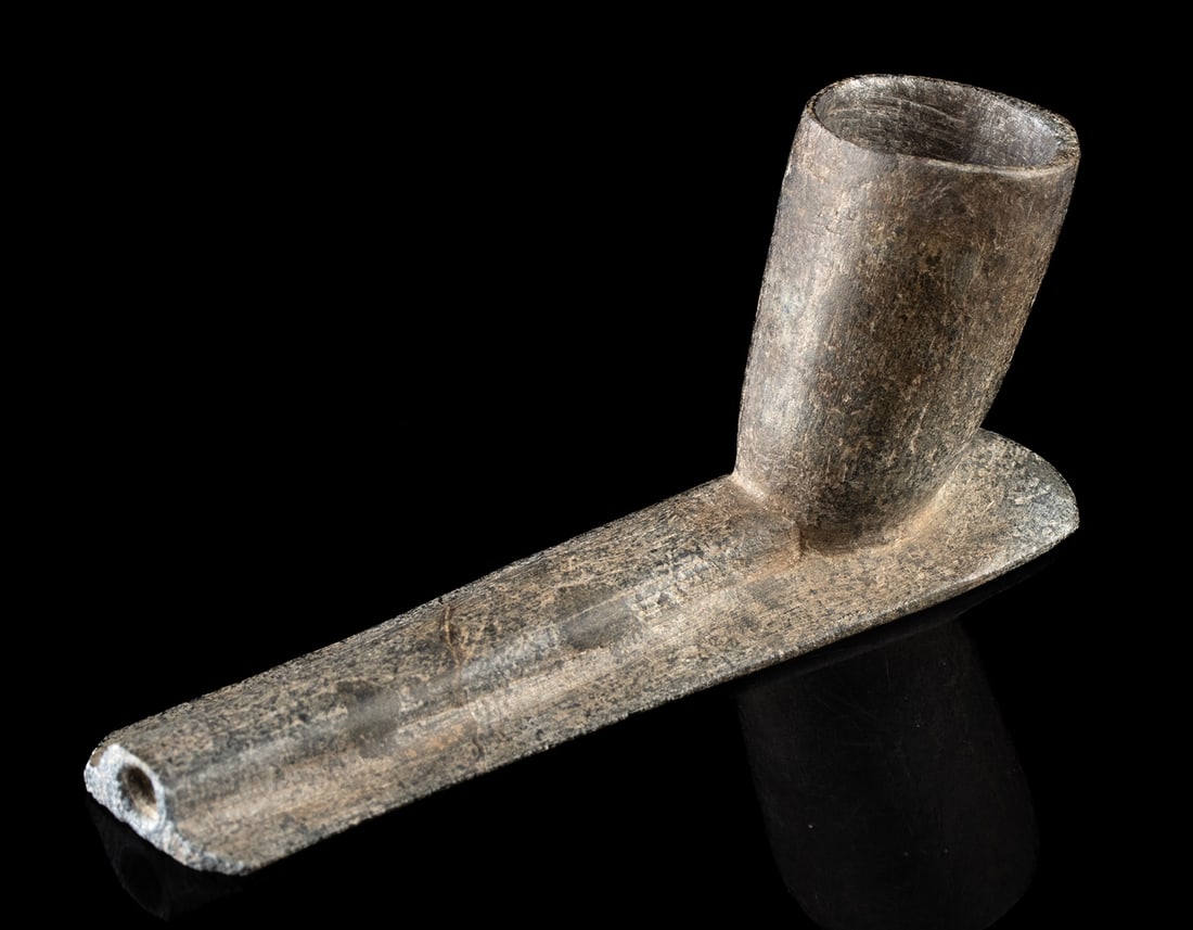 Woodland Stone Platform Pipe - Engraved Bowl: Native American, Eastern Woodlands, Woodland period, ca. 1000 BCE to 1000 CE. A compact and finely worked steatite obtuse platform pipe, its angled bowl rising from a flattened stem engraved with simp