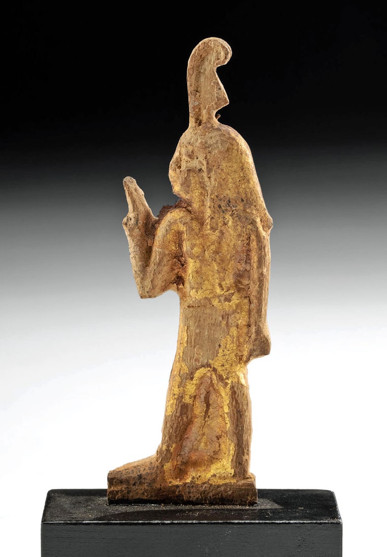 Egyptian Ptolemaic Gilded Wood Plaque - God Shu: Egypt, Ptolemaic period, ca. 305 to 30 BCE. A rare and impressive wood plaque of Shu, the Egyptian god of peace, lions, air, and wind who personifies the air, enveloped in lustrous remains of gilding.