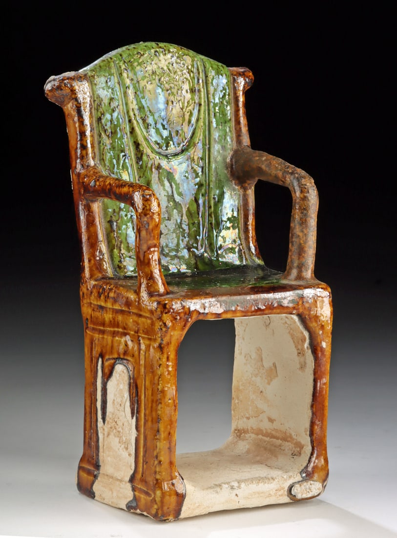 Chinese Ming Dynasty Sancai Pottery Chair, Tomb Mingqi: East Asia, China, Ming Dynasty, ca. 13th to 16th century CE. This miniature pottery chair effigy is modeled with squared legs and gently curving armrests, covered in a sancai-style glaze with mottled