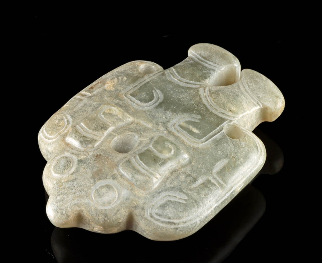 Chinese Nephrite Jade Carving of Avian Figure: East Asia, China, ca. 20th century CE. A jade pendant carved in the form of an avian or bat figure, rendered in a nephrite jade stone with cloudy translucence. The stylized form displays broad wings,