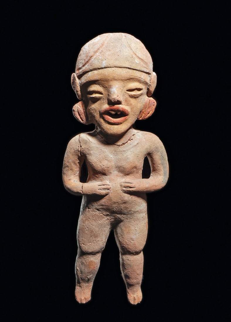Xochipala Standing Female Figure: Pre-columbian, Xochipala, ca. 1000 - 800 BCE. Natural buff color pottery standing figure, holding both hands on her stomach. Expressive facial features, open toothy mouth, domed headdress. Some remain