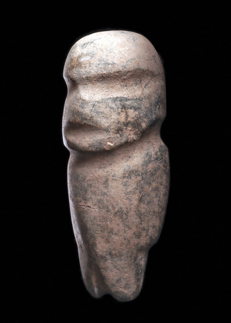 Guerrero Carved Hardstone Standing Figure, Dome Head: Guerrero. Ca. 400 BCE. Carved gray hardstone anthropomorphic standing figure, having a rounded body and large rounded head, with simple carved facial features, dome type head, recessed eyes and mouth,