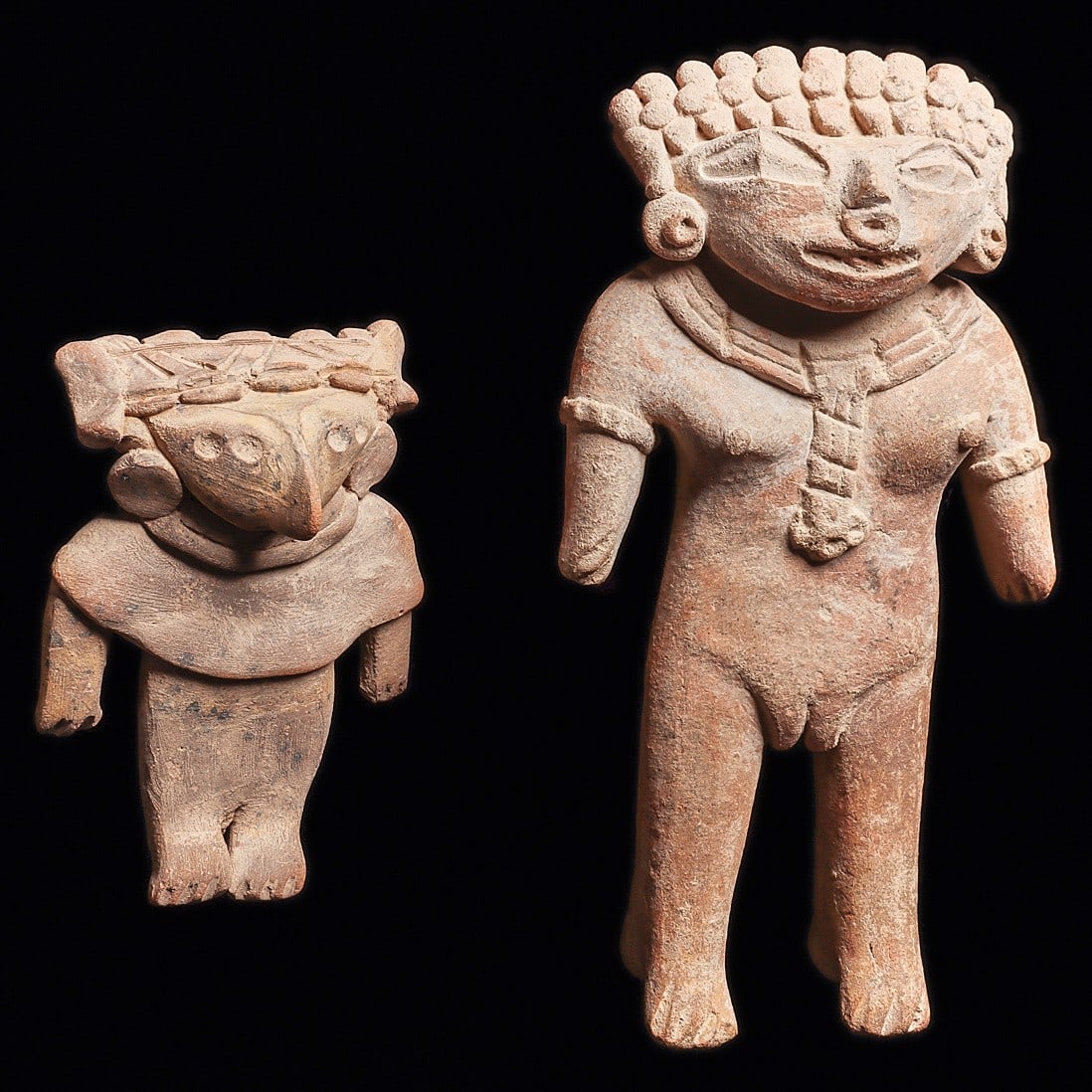Michoacan Standing Female Figures - Fancy Adornment: Michoacan. Ca. 400 - 100 BCE. Two different buff color solid pottery standing figures, the larger is depicted with a fancy hairdo with a center beaded band, disc ear ornaments and nose ring, fancy seg