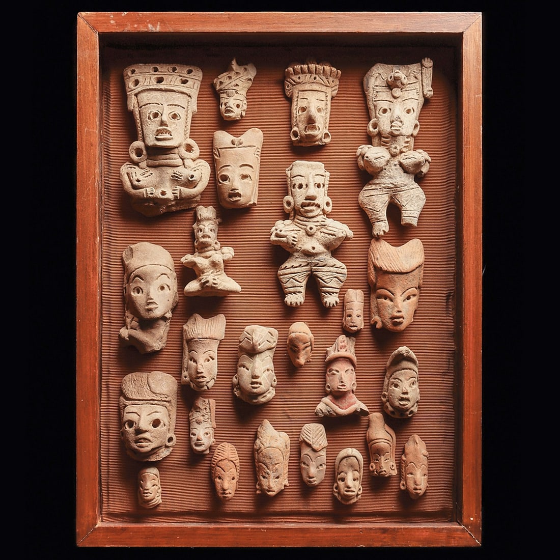 San Geronimo Heads & Figures in Frame (24): Guerrero. Ca. 400 BCE. Group of twenty four pottery examples, including four female figures and twenty heads, mostly San Geronimo. One figure missing legs, one missing a foot, the smallest figure with