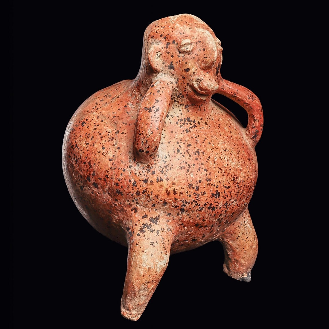 Colima Orange Ware Rotund Figure - Death Bubble, Hands to Jaw: Colima. Ca. 100 BCE - 250 CE. Orange ware pottery rotund figure having a large bulbous body, and both hands held to his jaw, a drug or death bubble between his lips. Overall scattered strong mineral d