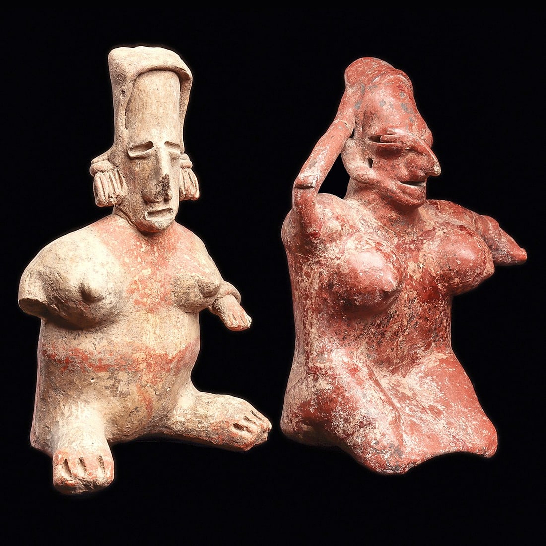 Jalisco Seated Figures (2): Jalisco. Ca. 100 BCE - 250 CE. Two different pottery seated female figures, including a red-brown slip San Sebastian figure, depicted with large round breasts, right arm held to her head and left arm 