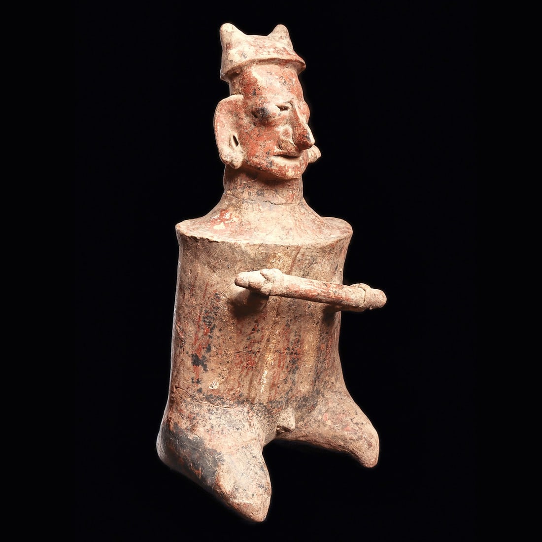 Jalisco Seated Warrior - Club & Barrel Armor, Double Pointed Helmet: Jalisco. Ca. 100 BCE - 250 CE. Large seated warrior, holding a club with both hands and wearing barrel armor, double pointed helmet and ear ornaments. Depicted with a large pointed nose and applied ba