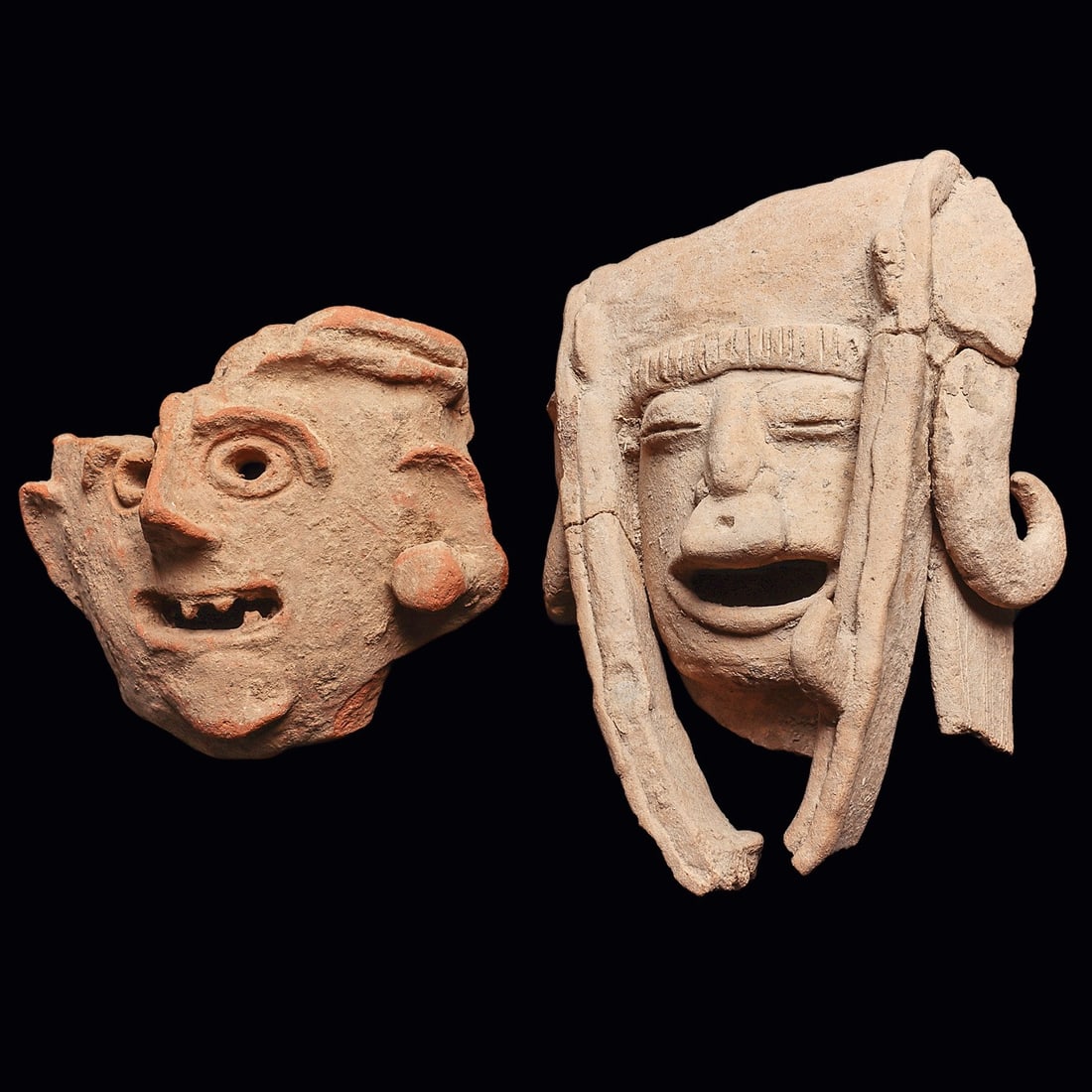 Veracruz Large Pottery Heads (2): Veracruz. Ca. 600 - 900 CE. Two different large fragmentary pottery heads, including a buff color example, originally from a figure, depicting a shaman wearing an elaborate headdress having a long chi