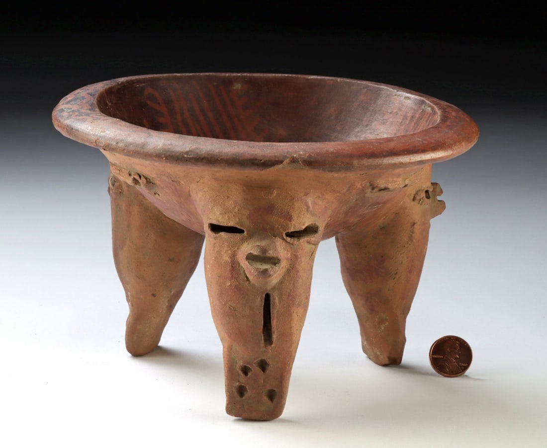 Nicoya Ceramic Tripod Bowl - Zoomorphic Rattle: Pre-Columbian, Costa Rica, Nicoya culture, ca. 500 to 1000 CE. A red-slipped tripod bowl of assured form, its three hollow rattle legs each modeled with a schematic avian face - slit eyes, a projectin