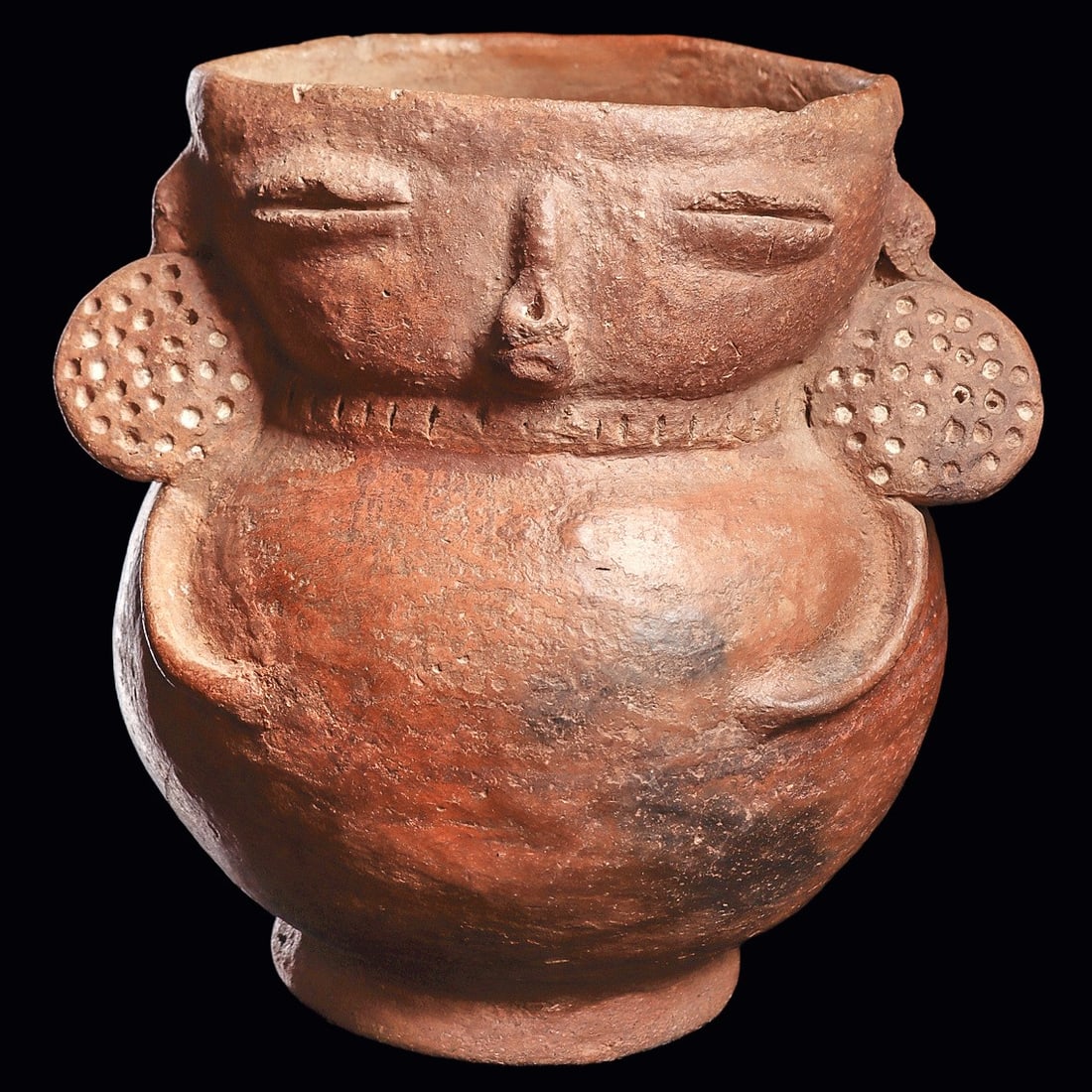 Panamanian Anthropomorphic Vessel, Ear Ornaments & Nose Ring: Panama. Ca. 800 - 1200 CE. Orange-brown pottery anthropomorphic vessel, having a bulbous body, and holding her very skinny arms on her stomach. Wearing large disc ear ornaments with impressed circular