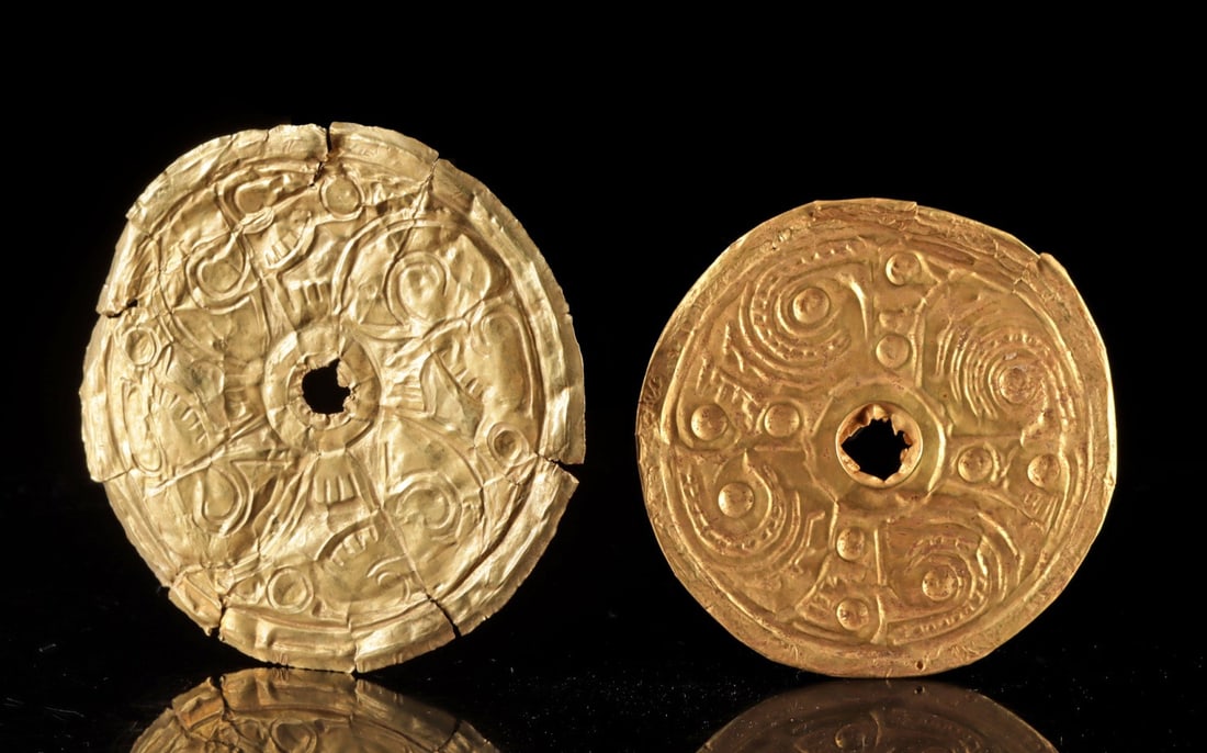Gran Coclé Gold Repousse Ear Ornaments Volute Scrolls: Pre-Columbian, Panama, Gran Cocle, ca. 700 to 1000 CE. Two repousse gold discs from the Gran Cocle cultural sphere of central Panama, each worked from high-karat sheet gold assaying at 85.14% and 80.2