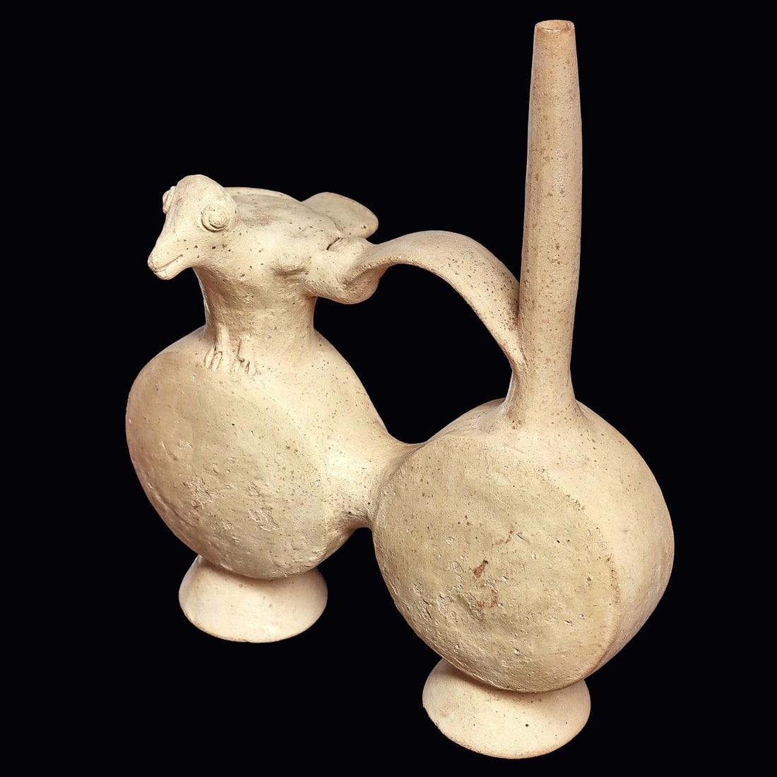 Chancay Whistle Bridge Vessel - Bird Effigy: Chancay. Ca. 1000 - 1250 CE. Cream slip pottery double lobe vessel having a tall slender rear spout, connected to a bridge type handle with a whistle incorporated in the handle, and connected to a bir