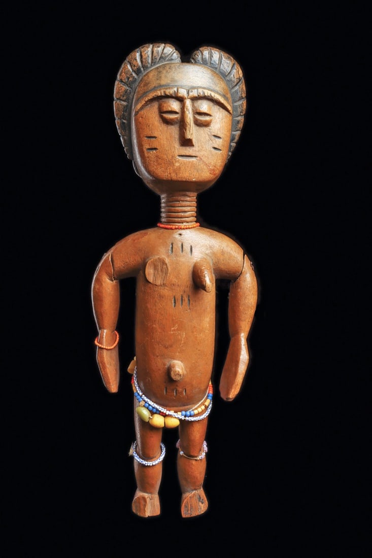 Fanti or Sefwi Fertility Figure: Ghana. Fine carved wood figure having four relief plaits around head, wide face with small relief coffee bean shape eyes, short ribbed neck, scarification along cheeks, torso, arms, and back. One