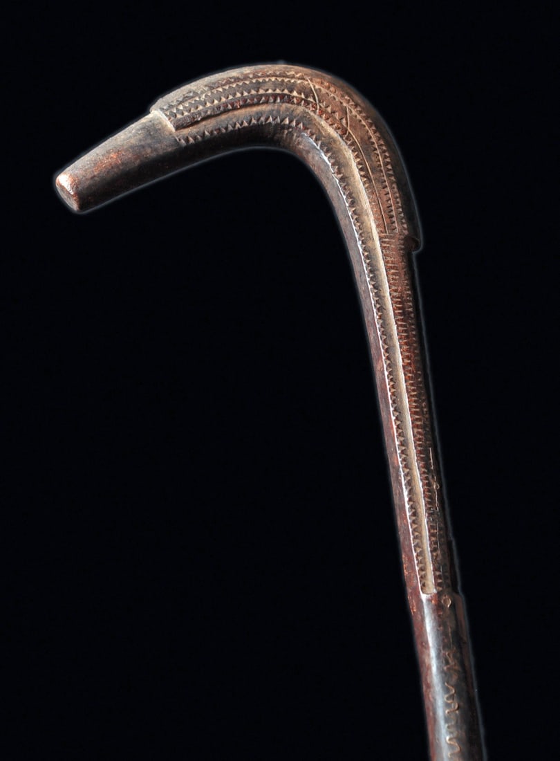 Dogon Staff: Mali. Abstract zoomorphic carving of hardwood with long zigzag lines running along the sides, hook finial with crest top indigenous repair with a zigzag metal wire embedded along mid-staff to bind