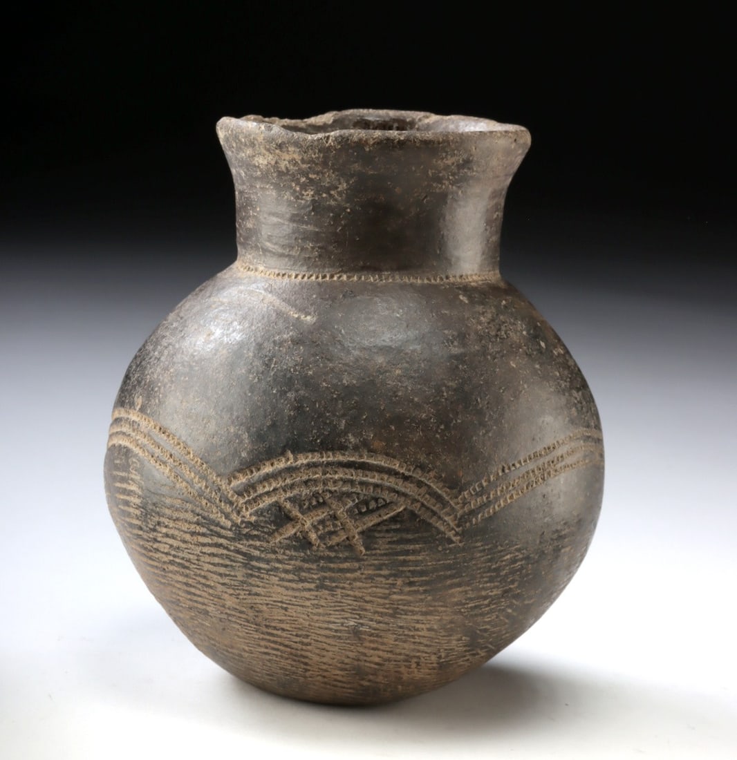 African Lobi Incised Pottery Vessel From Burkina Faso: West Africa, Burkina Faso, Lobi culture, ca. 19th to early 20th century. A hand-built earthenware pot with a rounded globular body and a short flaring neck, characteristic of traditional Lobi ceramic