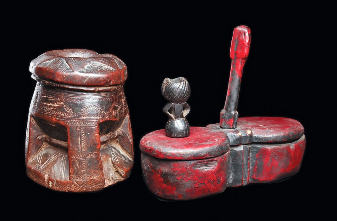 Group of Three Vessels: Cameroon. Palm butter vessel of heavy hardwood with engraved patterns. Loss at base. Red-brown old weathered patina. Together with a spice vessel, with sliding lid along vertical handle. Lastly a
