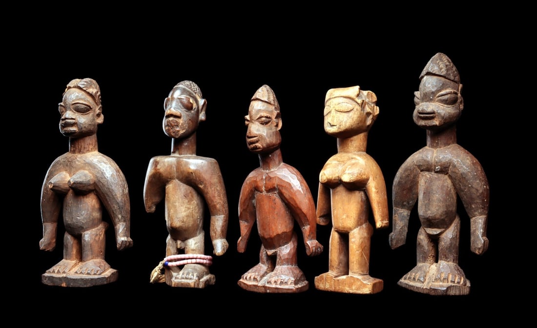 Ewe Twin Figures (5): Republic of Benin (ex. Dahomey). Group of twin figures freestanding on individual integral squared bases, carved with varying styles. One male with beaded strands shows losses along back and right han