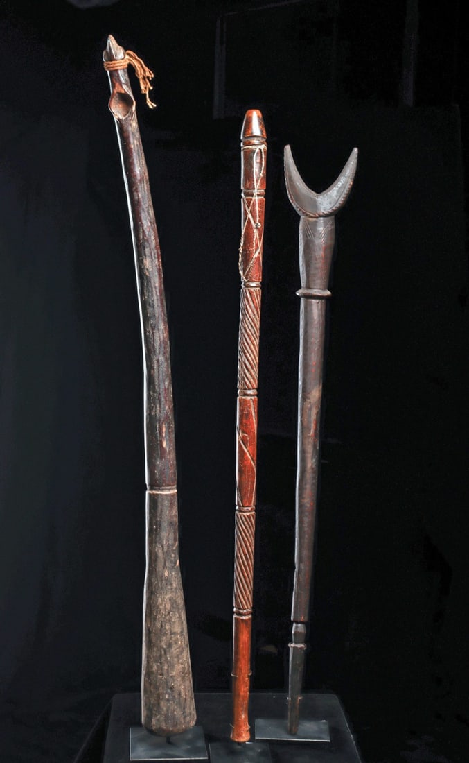 Horn Group (3): Tanzania and Burkina Faso.Long Zaramo side-blown horn with finial of a “mwana hiti” head accentuated with fiber tie. Long Mossi flute with crescent shaped mouthpiece, engraved x motif
