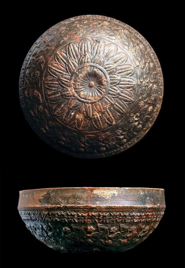 Megarian Ware Bowl: Eastern Mediterranean. Late Hellenistic, ca. 2nd - 1st century BCE. A shallow bowl of very fine detail with a pinkish hue, covered all over in a dark slip that ranges from dark brown to black. The dec