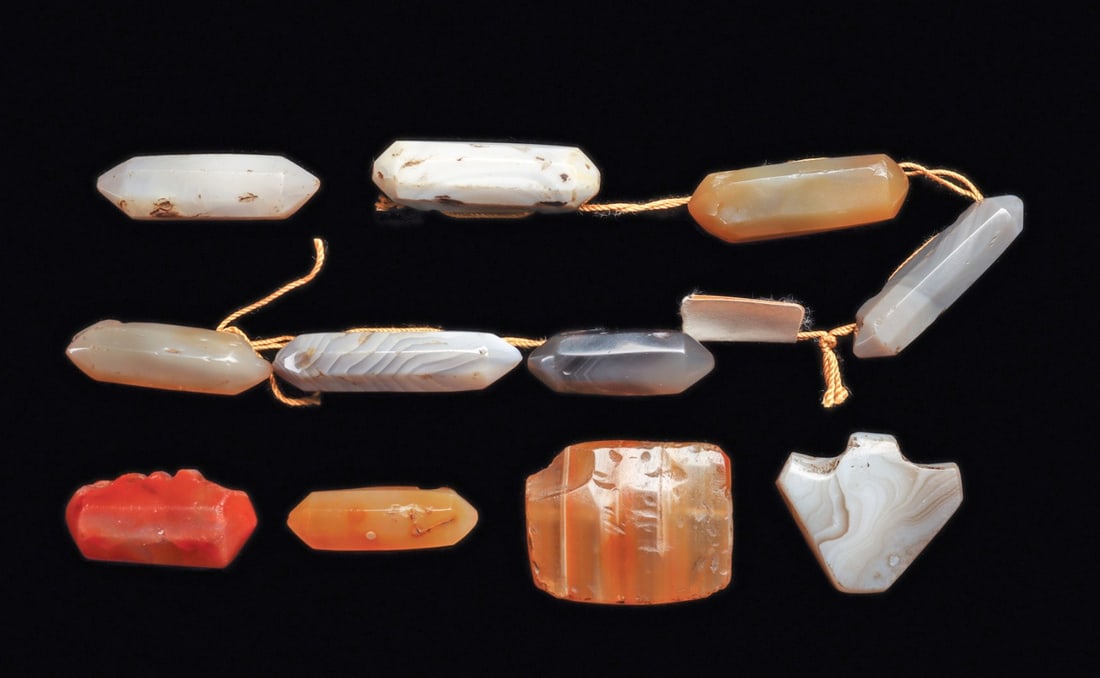 Nishapur Crystal Shape Agate & Carnelian Beads (11): Ancient Near East. Iran. Ca. 9th - 10th century CE. Group of eleven various color agate beads and pendants, the bead’s carved shapes, are seven sided prisms, inspired by naturally formed quartz 
