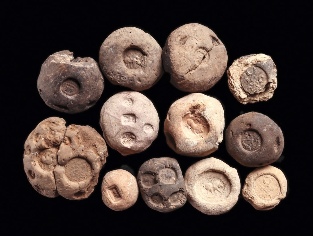 Sasanian Bullae with Various Stamp Impressions (12): Sasanian Empire. Western Asia. Ca. 5th - 6th century CE. Group of twelve different bullae, each originally attached to a document or merchant bundle, all having various stamp impressions including a w