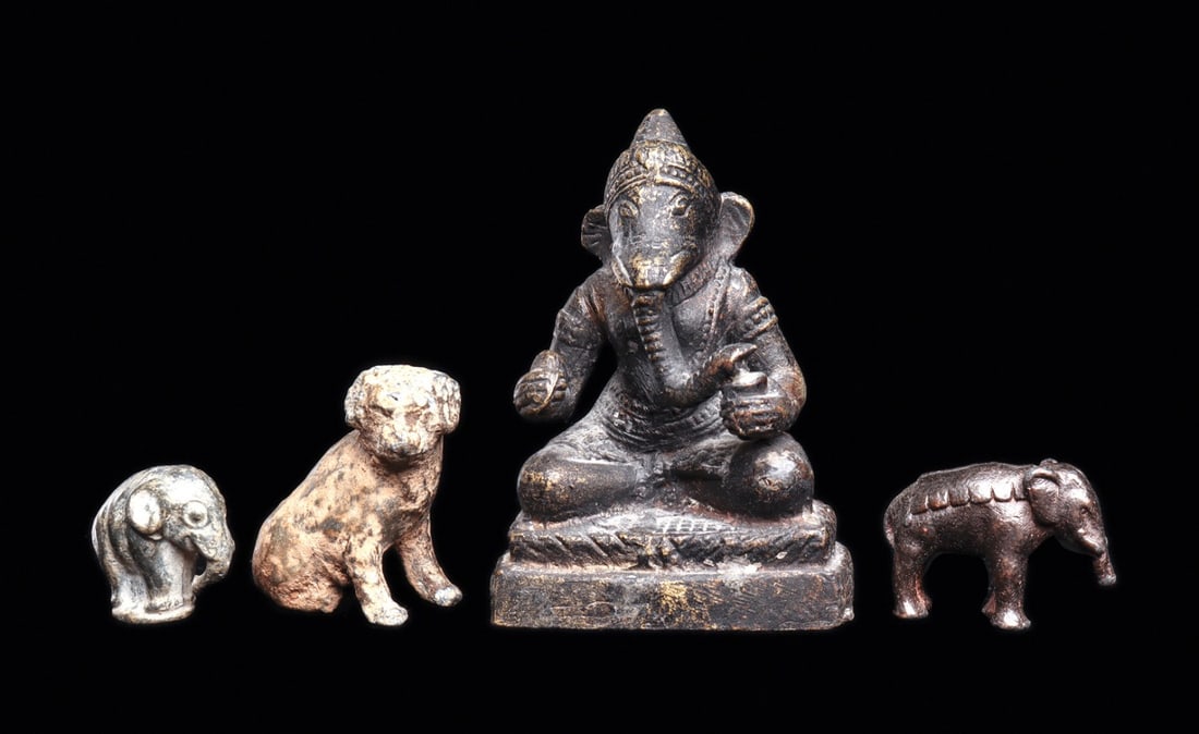 Seated Bronze Ganesh, Small Elephants & Dog (4): Asia. Ca. 19th to 1st half of 20th century. Four different examples including a cast bronze seated Ganesh, old black painted surface with high point wear, otherwise intact. Together with a solid cast 