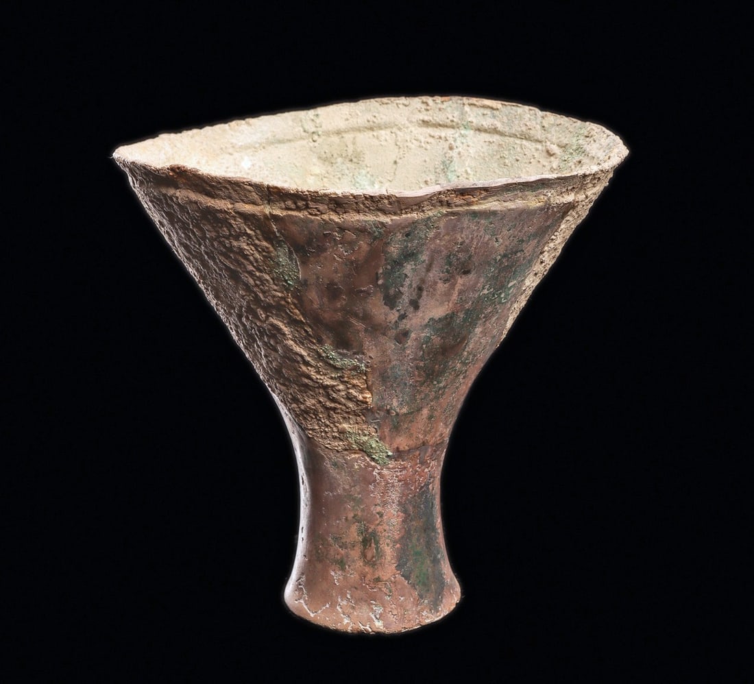 Han Dynasty Silver Funnel Shaped Vessel: China.Han Dynasty or earlier, ca. 1st millennium BCE. Sheet silver funnel shape drinking vessel having a wide flared mouth and flat base. Overall strong areas of surface encrustation over a blue-green