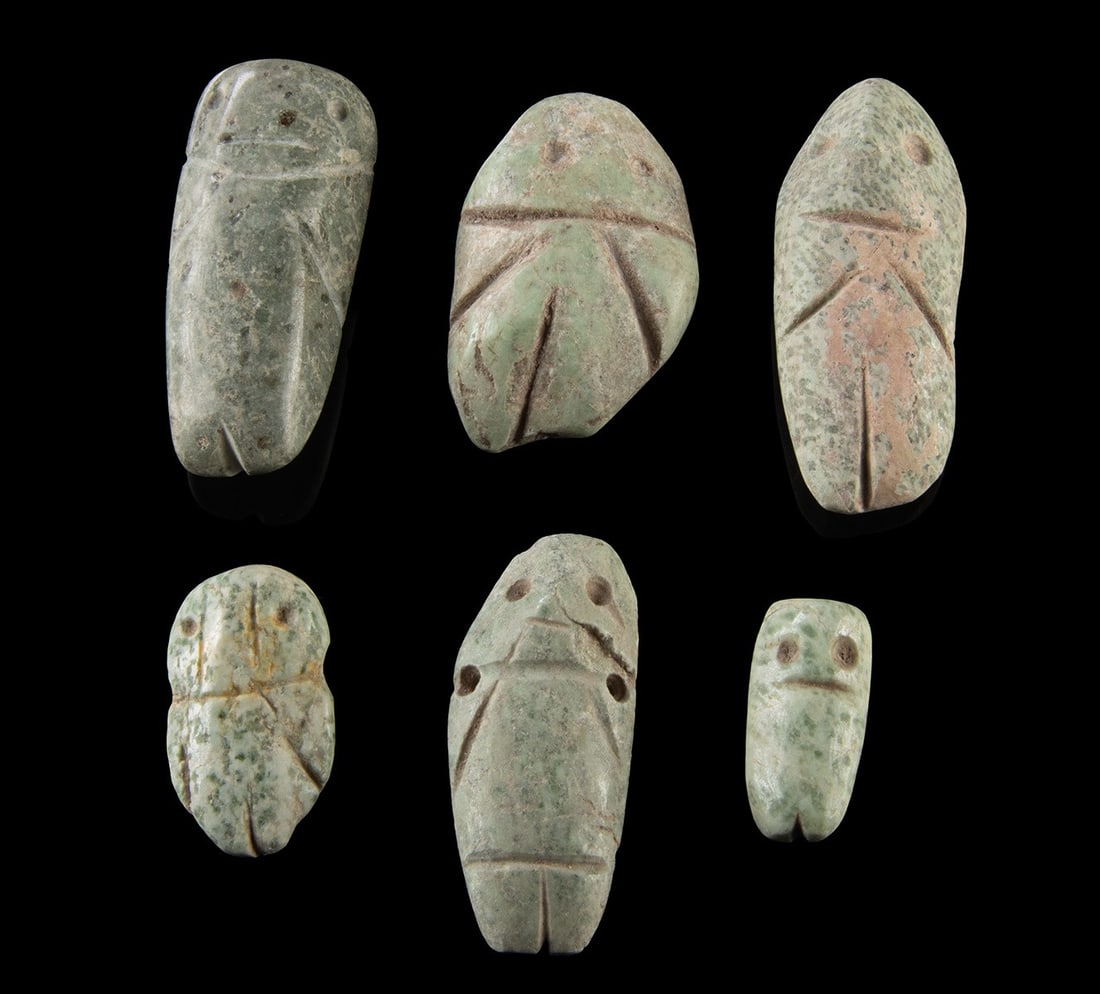 Six Mezcala Greenstone Figural Pendants: Pre-Columbian, West Mexico, Guerrero, Mezcala culture, ca. 200 BCE to 500 CE. A refined group of six Mezcala greenstone figural pendants reduces the human form to elegant geometry and sacred abstracti