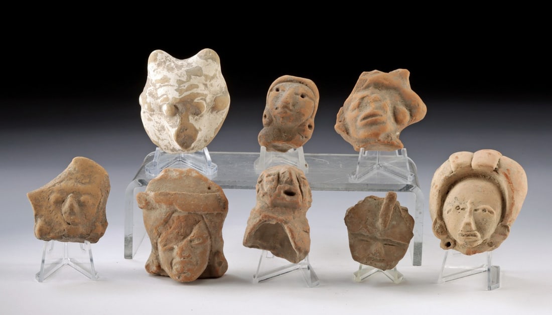 Lot of Eight Pre-Columbian Pottery Heads: Pre-Columbian, Mesoamerica and West Mexico, Multiple Cultures, ca. 300 BCE to 900 CE. A gathering of eight ceramic figurine head fragments representing the breadth and vitality of Pre-Columbian Mesoam