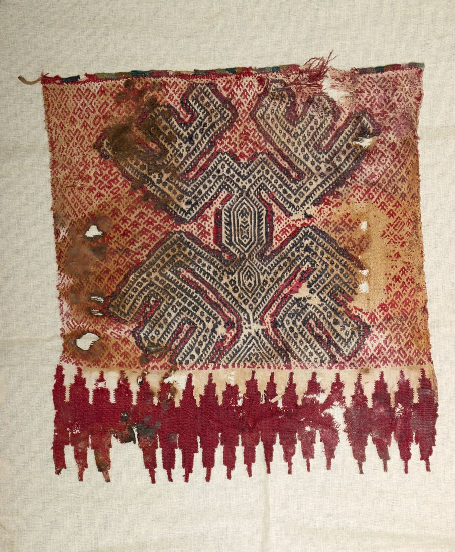 Chimu Wool Mantle Panel - Abstract Creature: Pre-Columbian, Central Coast Peru, Chancay, ca. 800 to 1450 CE. A mantle panel woven from camelid wool and cotton, featuring a large abstract creature surrounded by repeating geometric motifs rendered